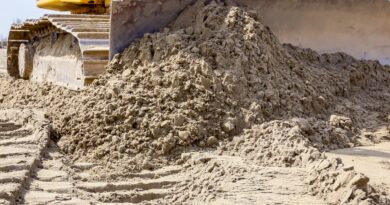 Close up of an earthmoving bulldozer track and blade pushing dirt.